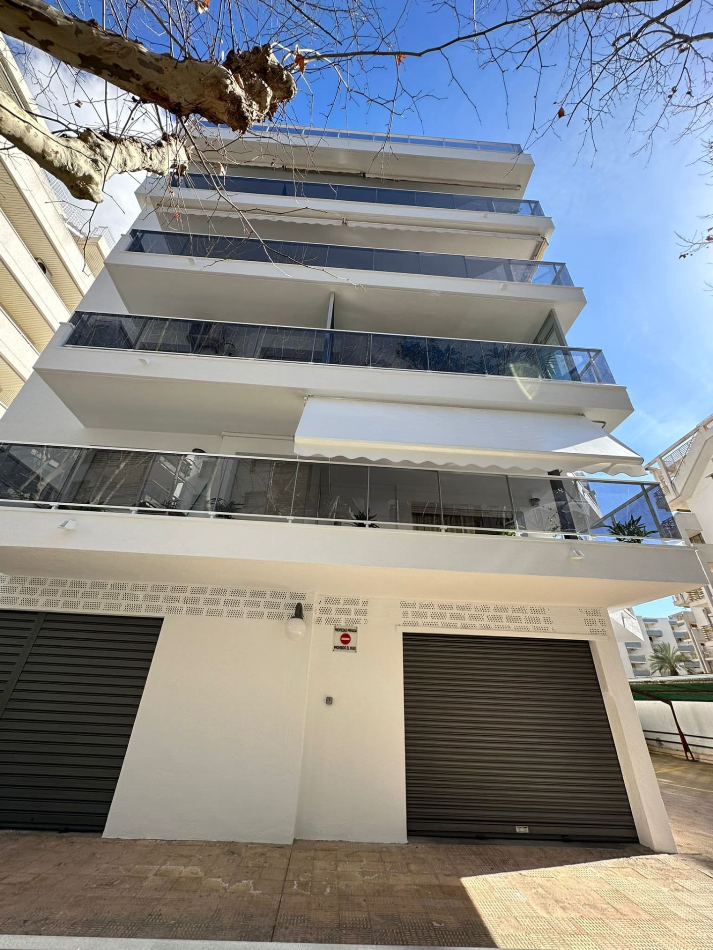 Façana blanca amb tancaments de vidre